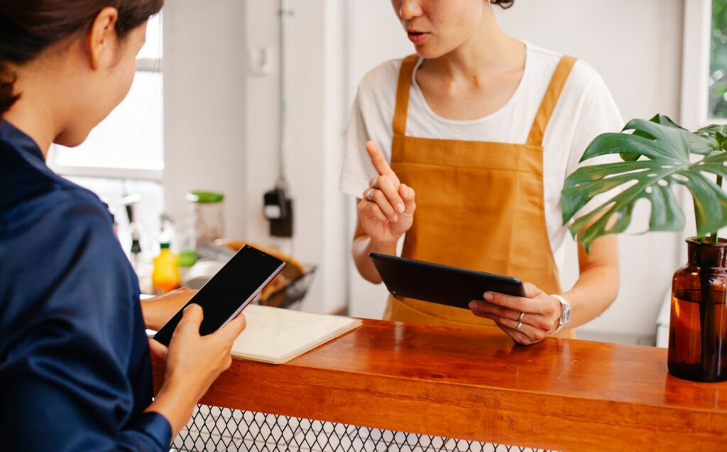 how to avoid getting your whatsapp number blocked - indian shop owner checking phone